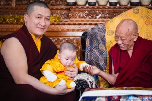 His Eminence Luding Khenchen Rinpoche and little Thugsey share a moment